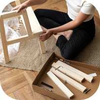 A man builds a wooden chair